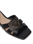 Sandali da donna in pelle nera con fascia e decorazione distintiva, vestibilità comoda e di alta qualità.